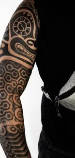 Bold tribal tattoo design on arm.