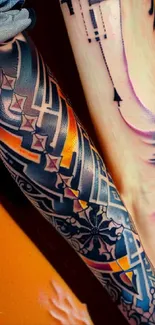 Mobile wallpaper featuring tribal tattoo designs with vibrant colors on arms.