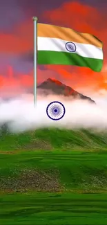 Indian flag waves above a misty mountain at sunset.