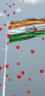 Indian flag waving with red hearts against a blue sky.