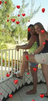 Two friends on a tropical balcony with trees and tiles.