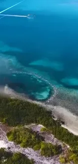 Aerial view of a tropical island with teal waters and lush green coastlines.