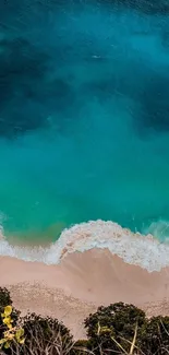 Aerial view of turquoise sea meeting sandy beach.