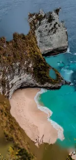 Aerial view of a tropical beach with turquoise water and dramatic cliffs.