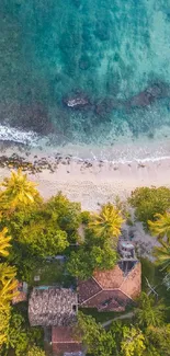 Aerial view of a tropical beach with turquoise water and lush greenery.