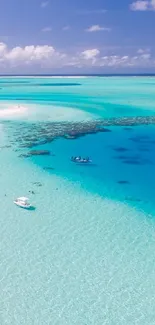 Aerial view of a tropical beach with turquoise waters and lush greenery.