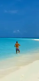 Man enjoying serene beach with turquoise water and white sand.