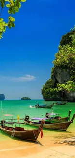 Tropical beach with boats and turquoise water under a blue sky.