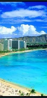 Tropical beach with city skyline and mountains under clear blue sky.