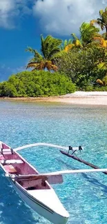 Tranquil tropical beach with a small boat on clear blue water.