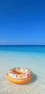 Tropical beach wallpaper with colorful float on clear blue water.