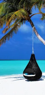 Tropical beach with hammock under palm tree set against blue ocean.