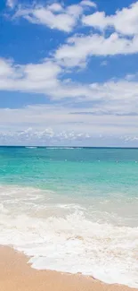 Serene tropical beach with clear sky and turquoise waves.