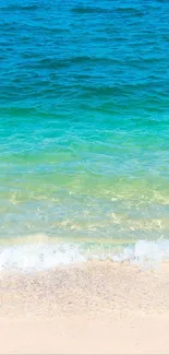 Tropical beach with turquoise ocean and sandy shore in mobile wallpaper.