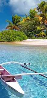 Tropical beach with clear water and a wooden canoe in the foreground.