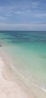 A breathtaking view of a tropical beach with turquoise waters and a sandy shore.