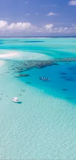 Aerial view of a tropical beach with azure blue waters and white sandy shores.