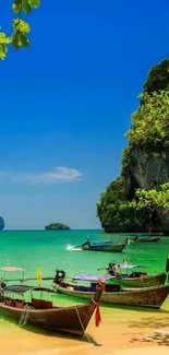 Tropical beach with turquoise sea and Thai boats under clear blue sky.