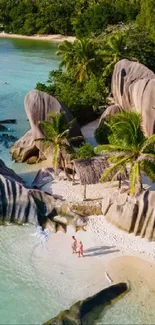 Aerial view of a tropical beach with turquoise waters and granite rocks.