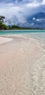 Tropical beach scene with turquoise water and sandy shore.