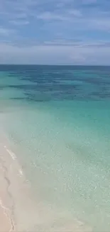 Tropical beach with turquoise waters and sandy shore.