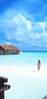 Tropical beach scene with azure sky, a wooden house on stilts, and a woman walking.