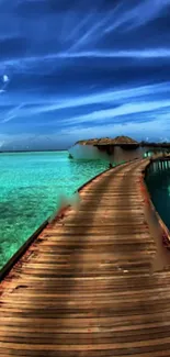 Wooden pathway over turquoise water under a vibrant blue sky on a tropical beach.