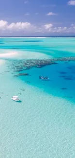 Aerial view of tropical beach with turquoise water and lush foliage.