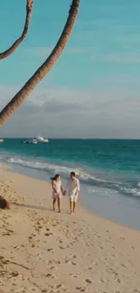 Couple walking on a tropical beach under palm trees.