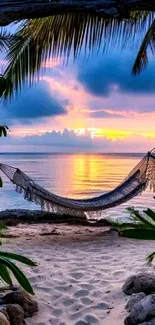 Scenic tropical beach with sunset and hammock.