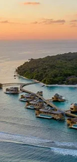 Tropical island resort with sunset over blue ocean.