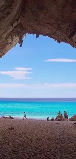 Mobile wallpaper with a tropical cave view of a turquoise beach.