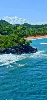 Tropical coastline with blue ocean and lush greenery.