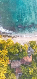 Aerial view of a tropical beach with green forest and turquoise waters.