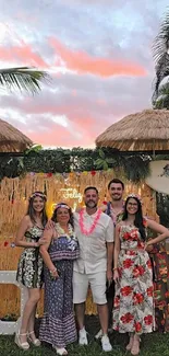 Tropical-themed family gathering with festive decor and palm trees under a sunset sky.