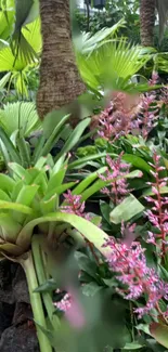 Wallpaper of a tropical garden with lush green plants and pink flowers.