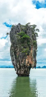 Tropical island with towering cliffs and serene ocean view.