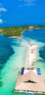 Tropical island with turquoise waters and sandy path extending into the ocean.