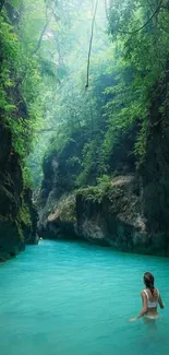 Woman exploring serene turquoise waters in lush tropical canyon.