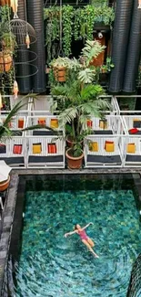 Woman floating in a tropical green pool surrounded by plants.