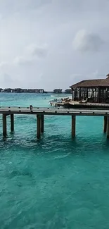 Tropical pier with turquoise ocean and clear skies.