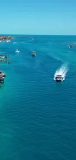 Tropical ocean view with boats and clear blue water.