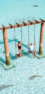 Couple swinging over crystal-clear ocean waters, capturing a tropical paradise feel.