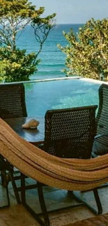 Tropical ocean view with a hammock and an infinity pool in a lush setting.