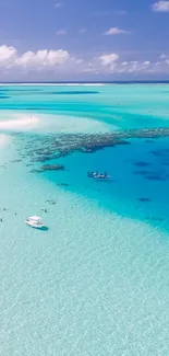 Aerial view of tropical beach with turquoise waters and lush greenery.