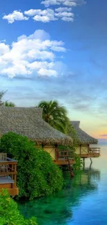 Tropical beach with bungalows and blue ocean at sunset.