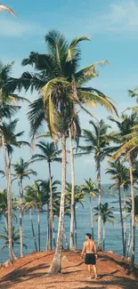 Tropical island with palm trees by a blue ocean under clear skies.