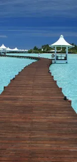 Tropical pier over turquoise water with clear skies.