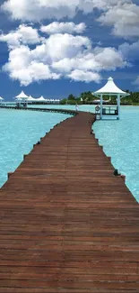 Tropical pier extending over blue waters under a clear sky.