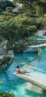 Woman relaxing by the tropical pool surrounded by lush greenery.